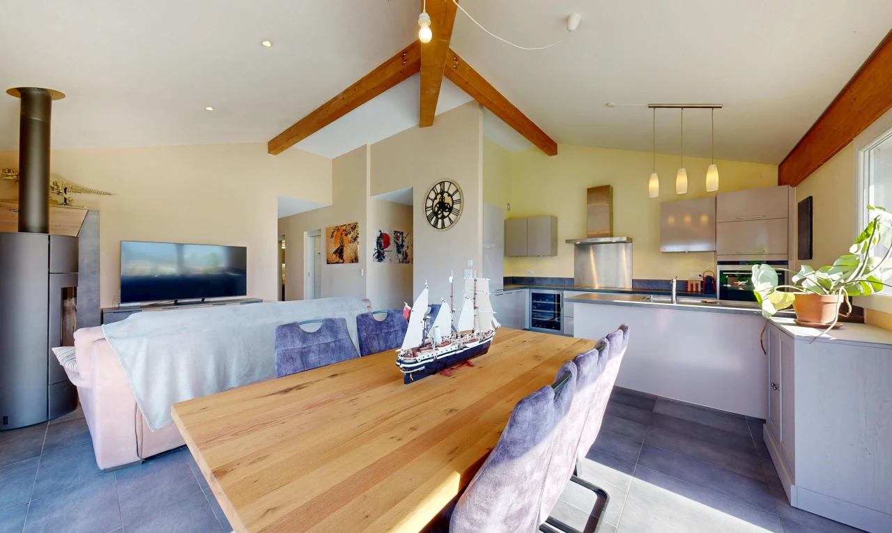 salon / salle à manger avec high end ceiling, vaulted ceiling, plafond voûté, télévision, et éclairage suspendu