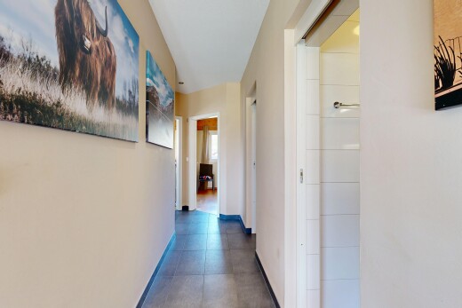 couloir avec inside property, cloison sèche, drywall, plinthes murales, et baseboards wall