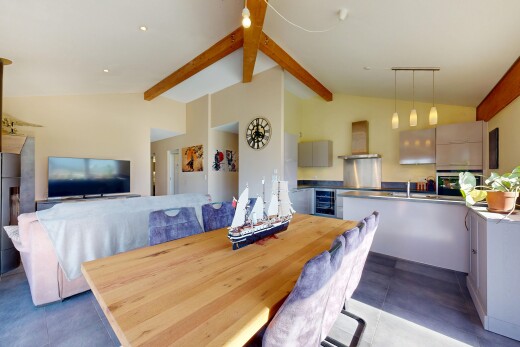 salon / salle à manger avec high end ceiling, vaulted ceiling, plafond voûté, télévision, et éclairage suspendu
