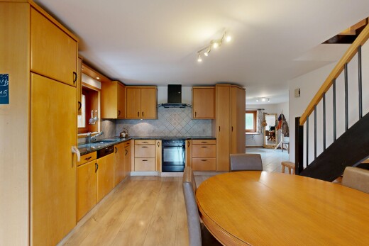 küche mit dark countertops, treppen, light floor, dunstabzugshaube, und ofen