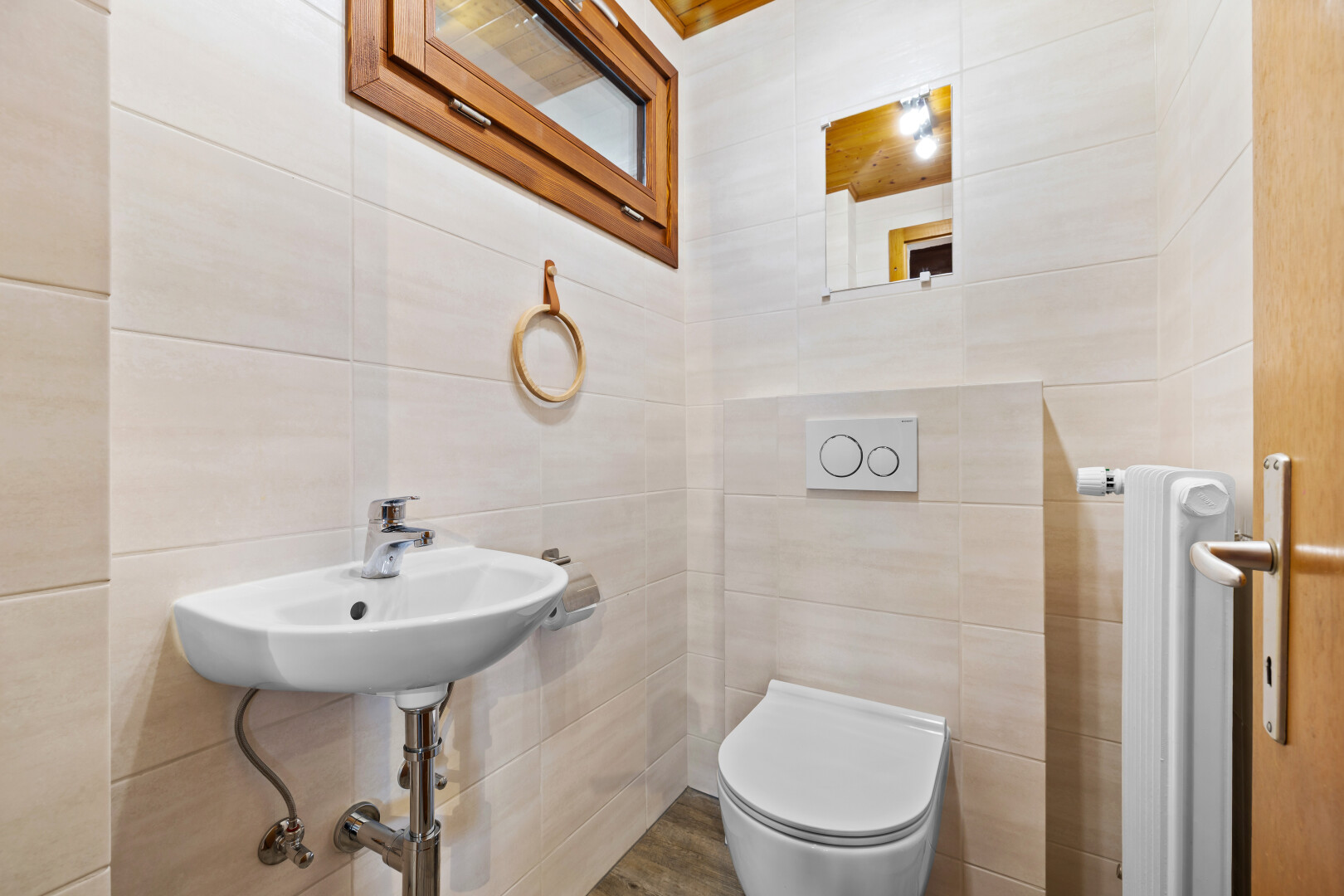 salle de bains avec toilette, tile wall, mur en carrelage, inside property, et évier