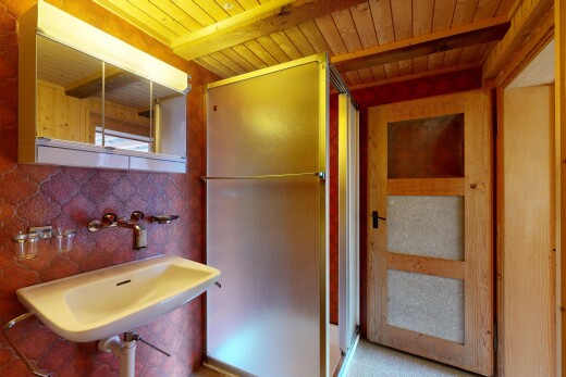 full bath featuring a stall shower and a wooden ceiling with exposed beams