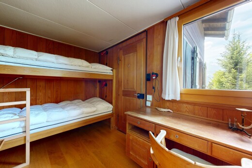 room / bedroom with wood walls and light wood-type flooring
