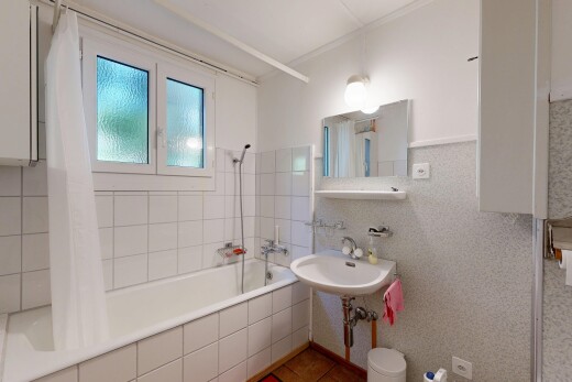 full bath featuring tiled shower / bath, tile walls, and light tile patterned floors