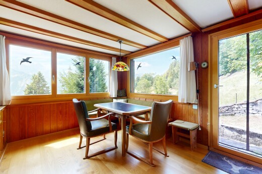 dining area featuring wooden walls, plenty of natural light, and light wood-style flooring