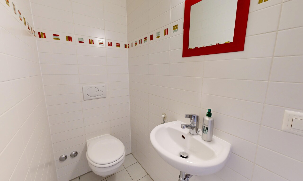 salle de bains avec inside property, miroir, toilette, évier, et tile floor