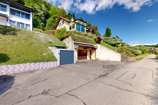 view of home with asphalt driveway