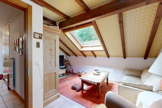 tiled living room featuring a skylight and beamed ceiling