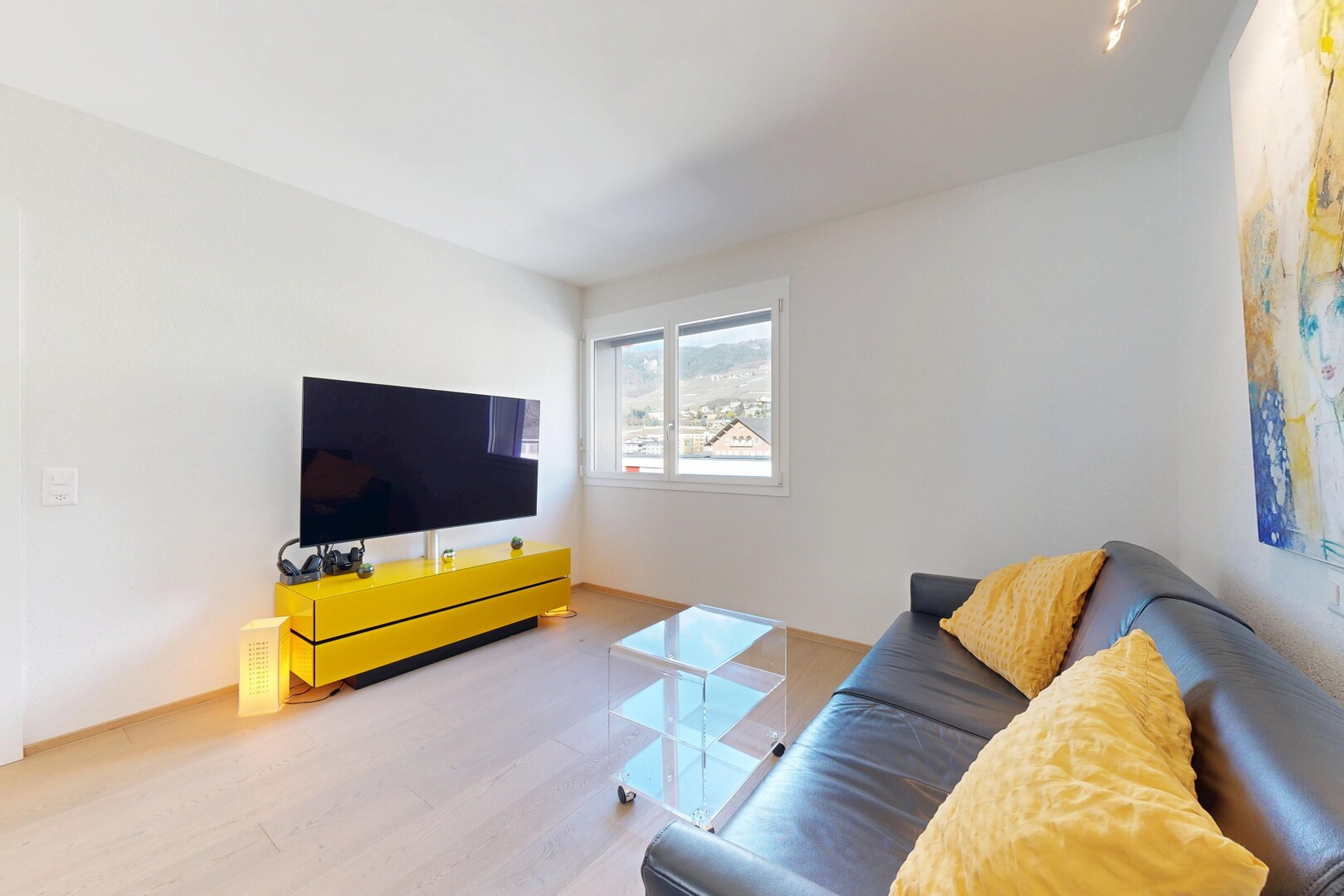 salon avec télévision, inside property, wood finish floor, sol en finition bois, et drywall
