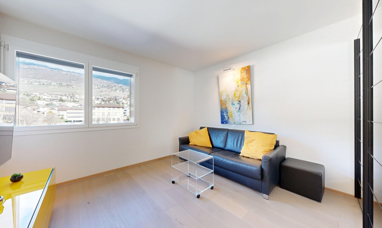 salon avec sol en finition bois, wood finish floor, inside property, lumière naturelle, et natural light