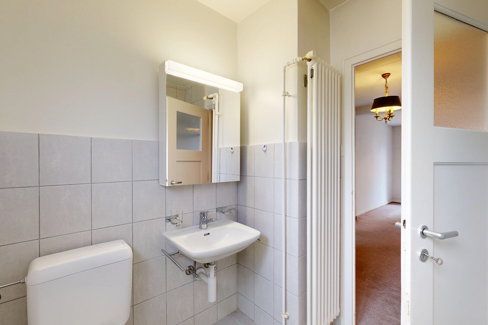 bathroom featuring tile walls and carpet