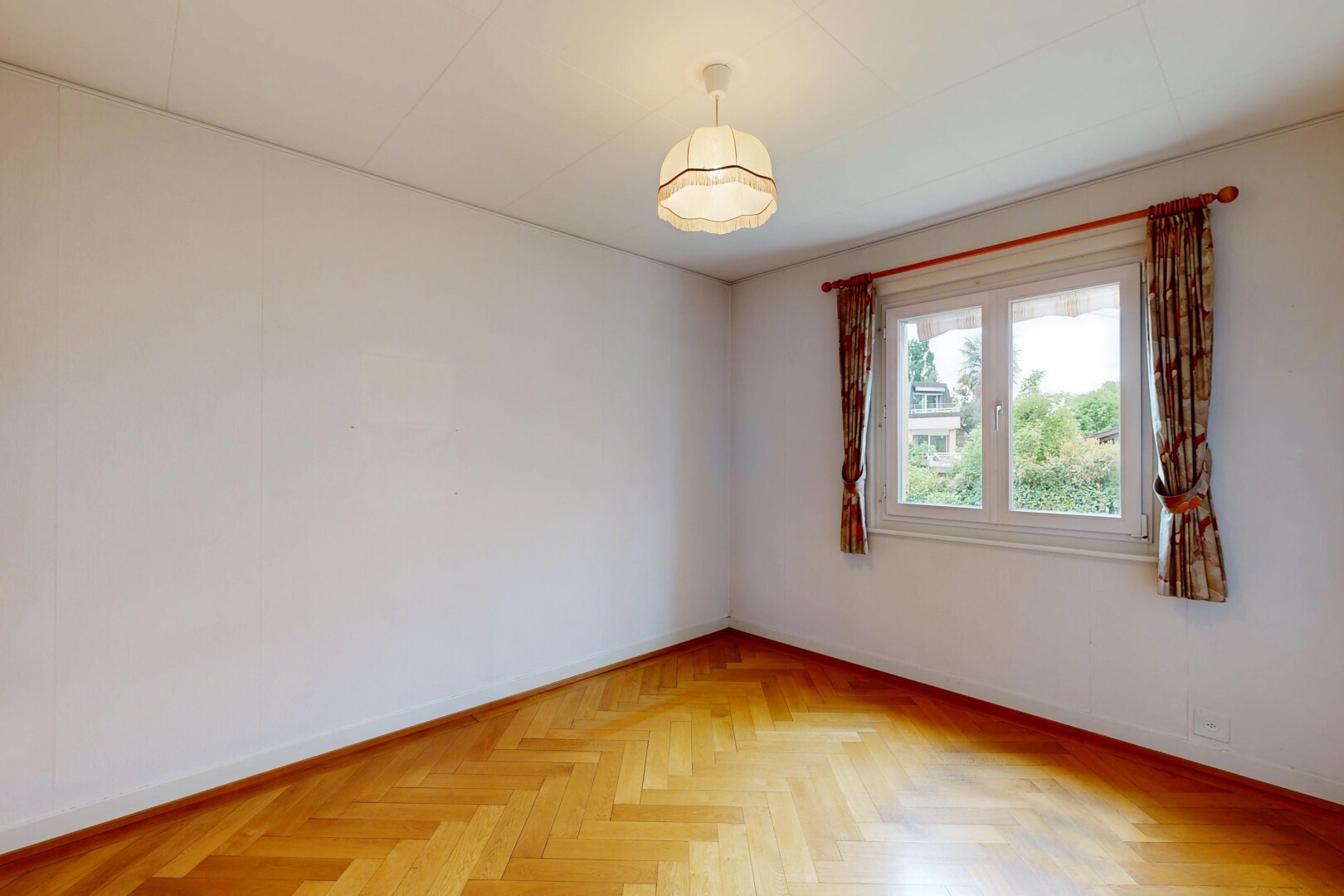 empty room with parquet floors and baseboards