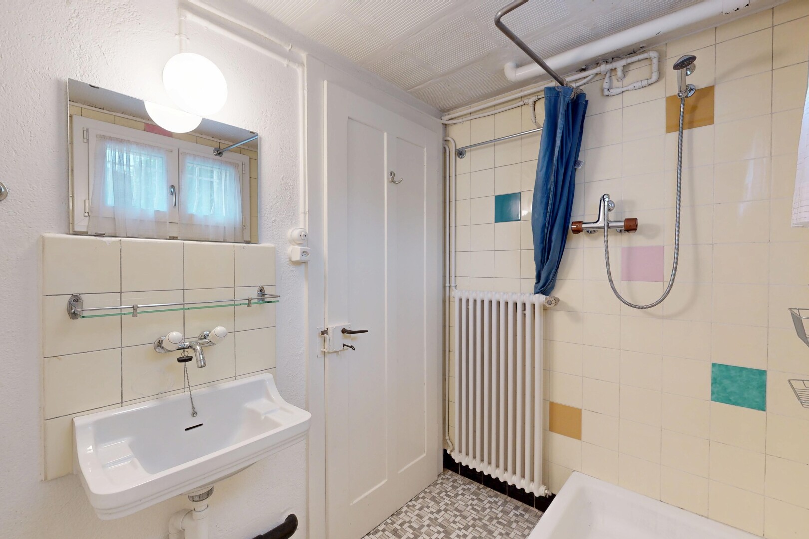 full bath with radiator and a tile shower