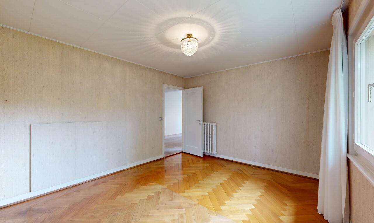 empty room with parquet flooring and radiator
