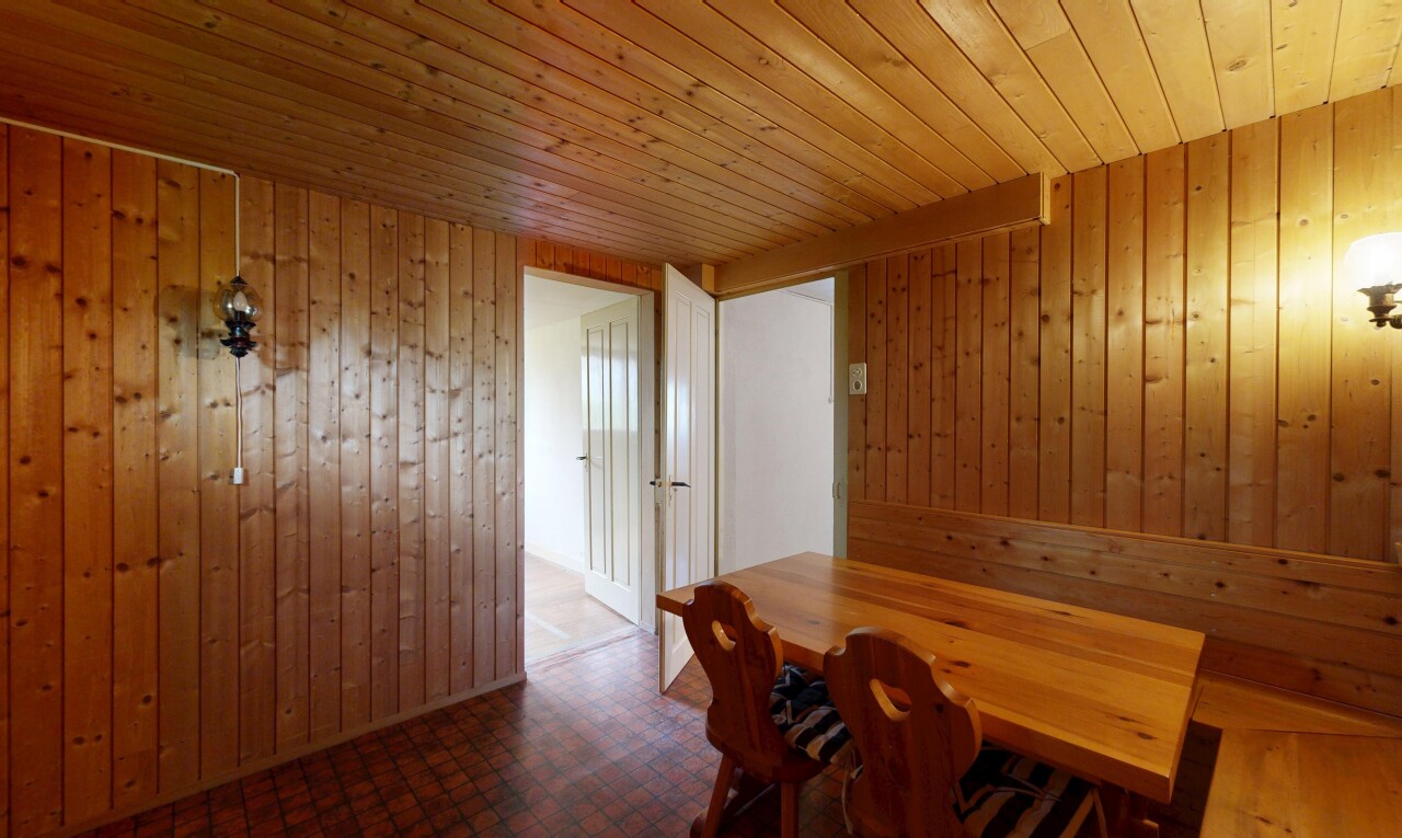 unfurnished dining room featuring wood ceiling and wooden walls