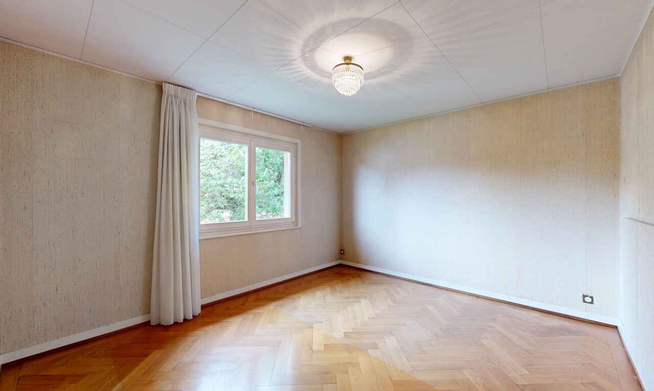 spare room featuring parquet floors and baseboards