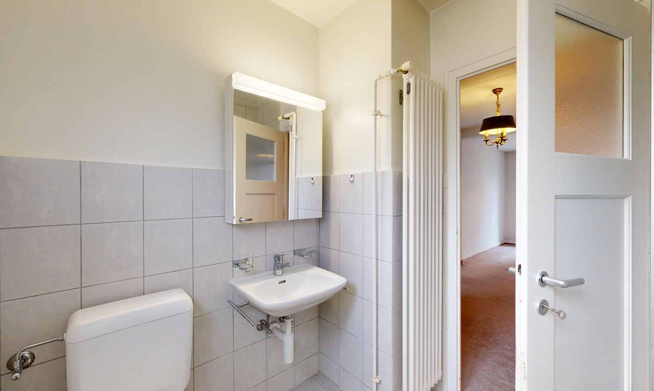 bathroom featuring tile walls and carpet