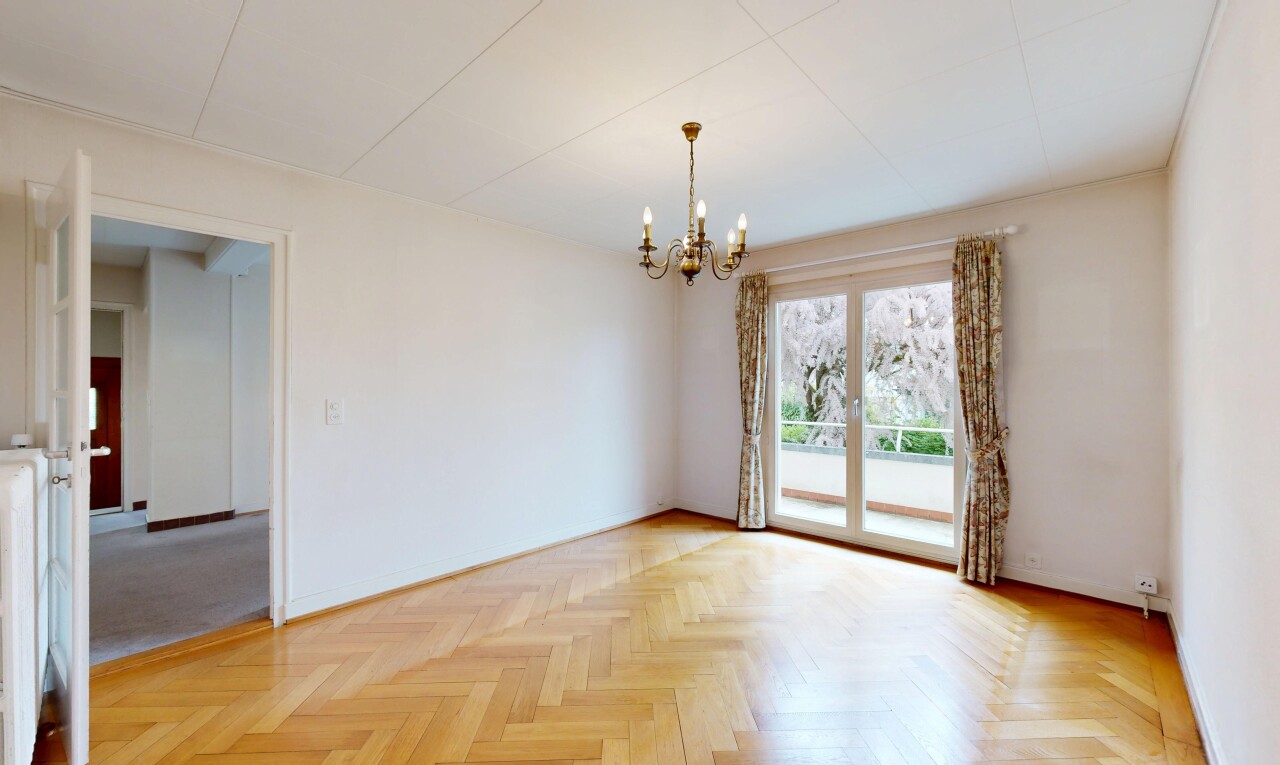 spare room with parquet flooring and hanging lights