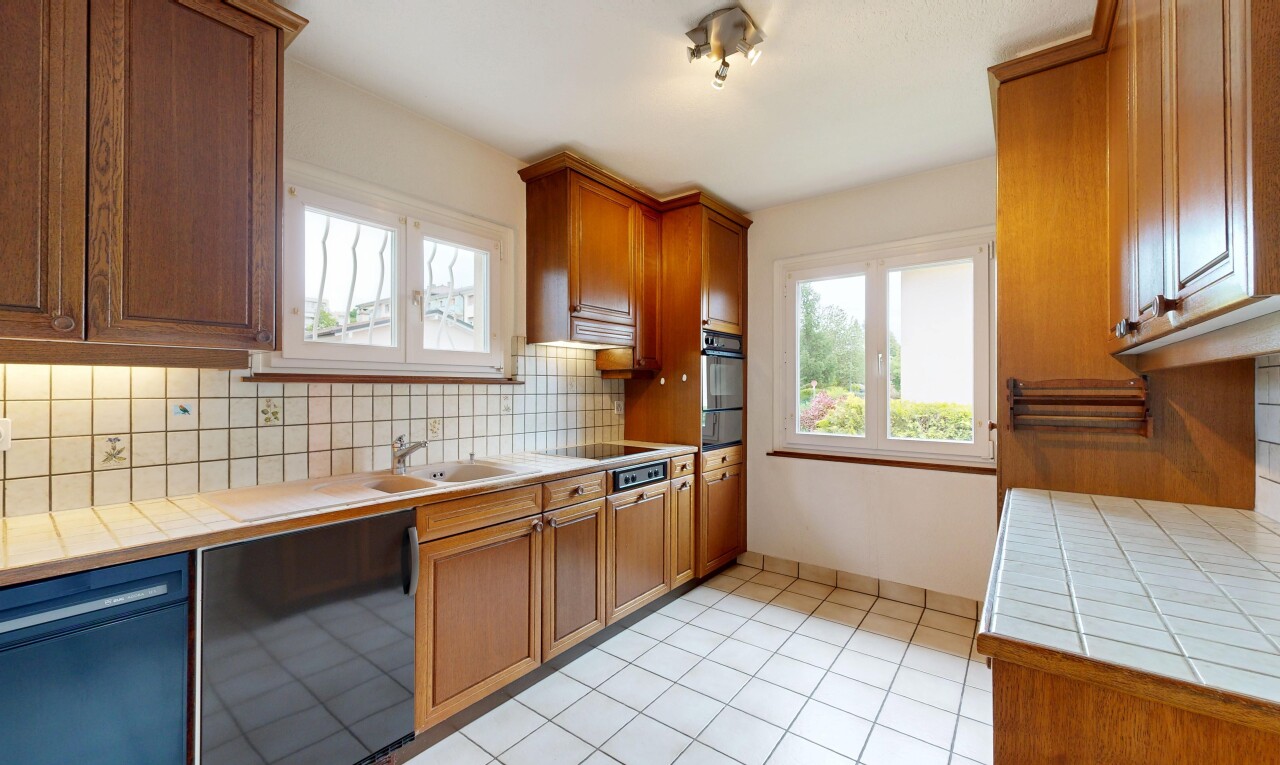 kitchen featuring tile countertops, black dishwasher, wood finish cabinetry, wall oven, and decorative backsplash