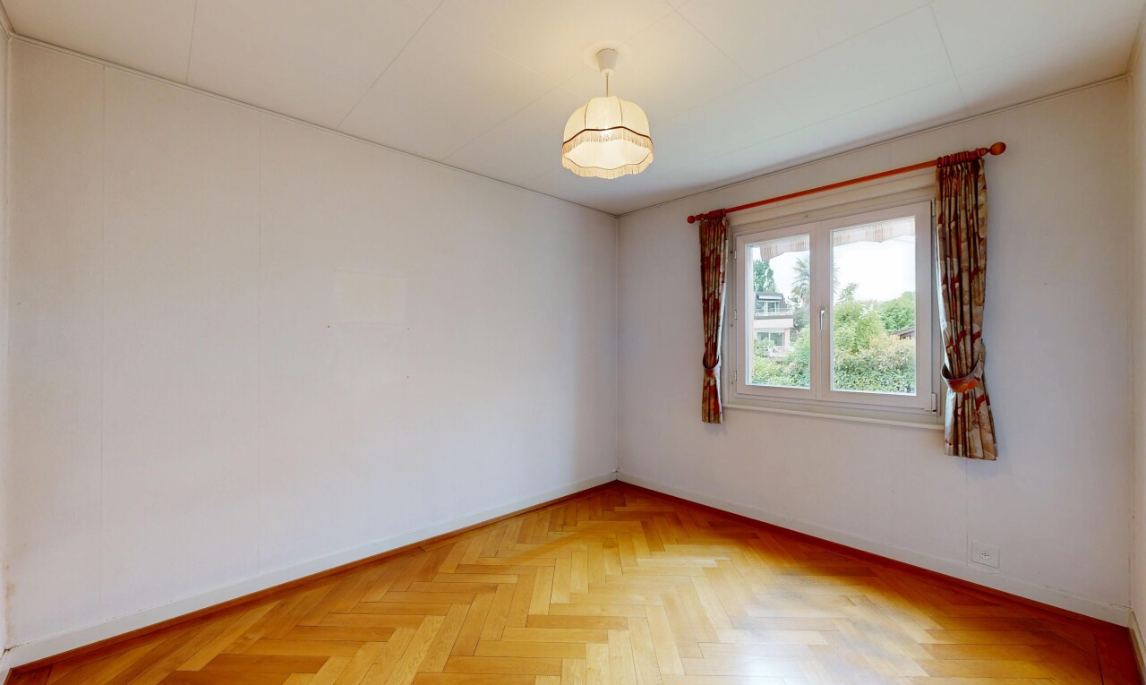 empty room with parquet floors and baseboards