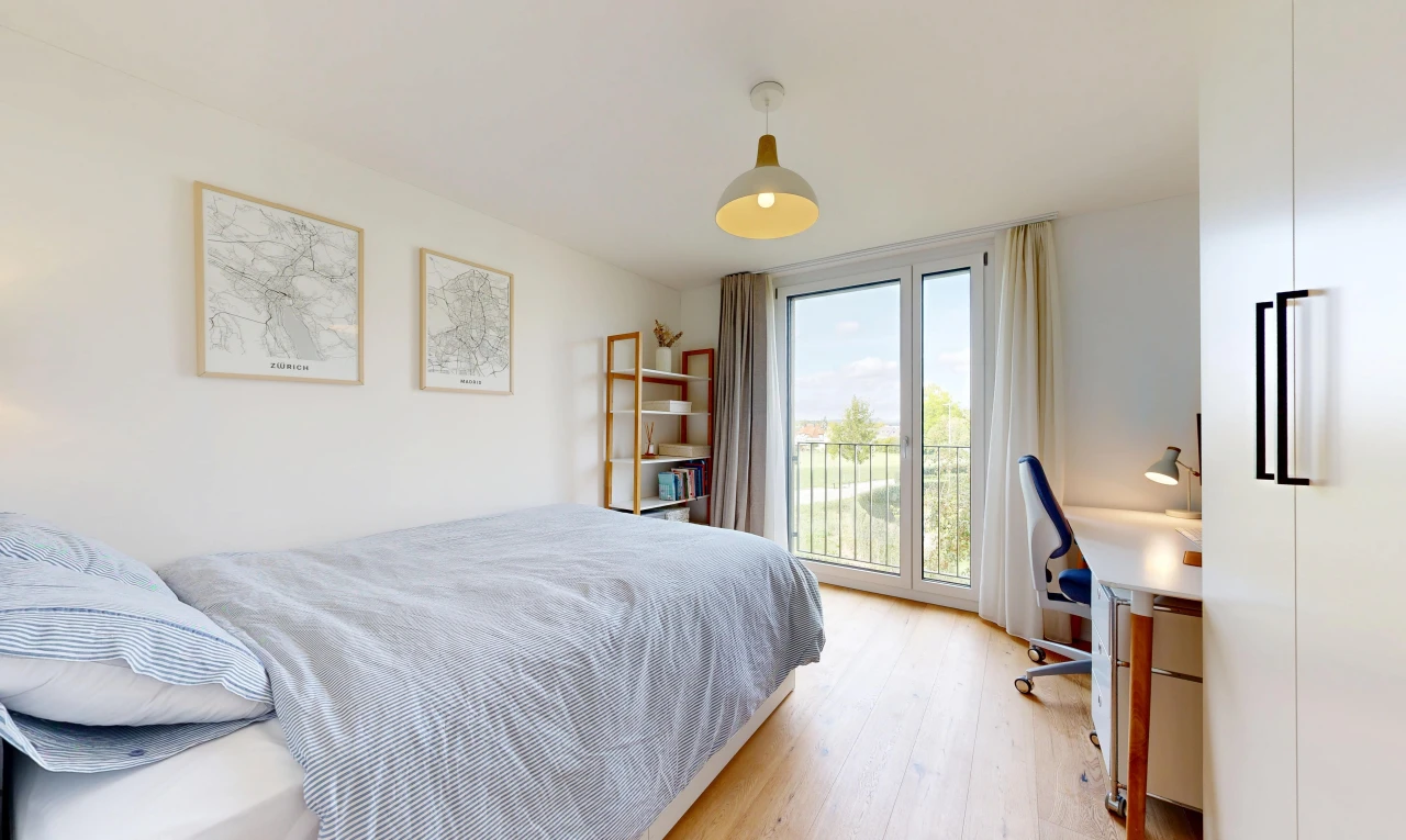 zimmer / schlafzimmer mit außenzugang, bürobereich, pendelleuchte, day time, und holzfußboden