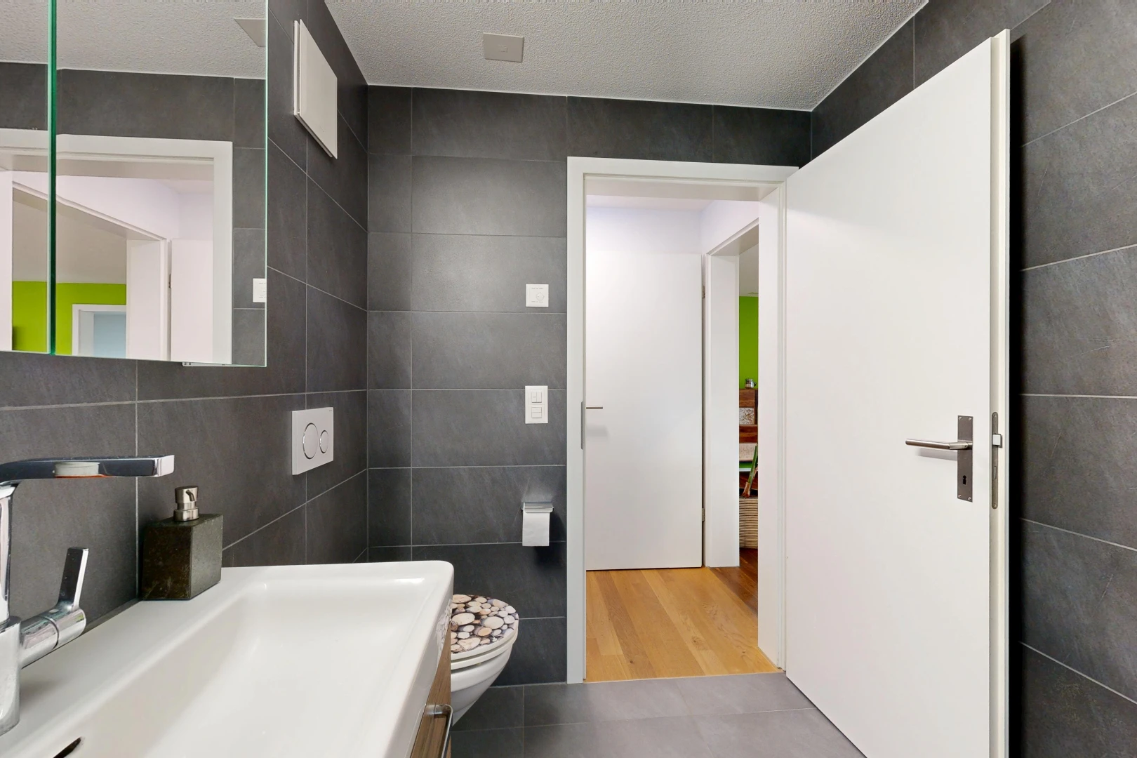bathroom featuring tile walls and a textured ceiling