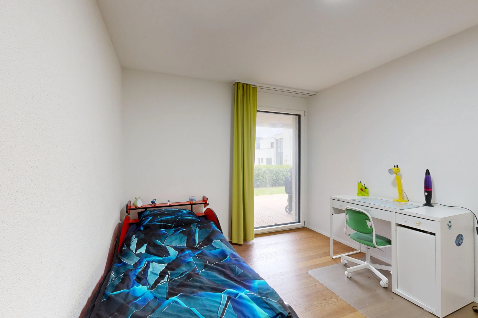 room / bedroom featuring an office area, light wood-style flooring, and access to outside