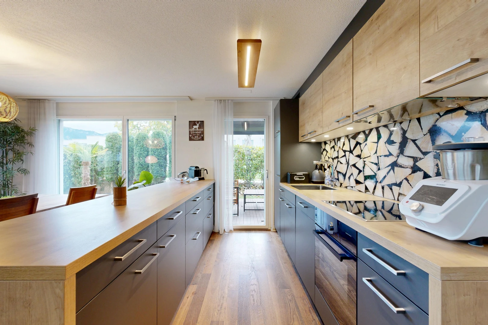 kitchen with light countertops, black appliances, modern cabinets, and access to outside