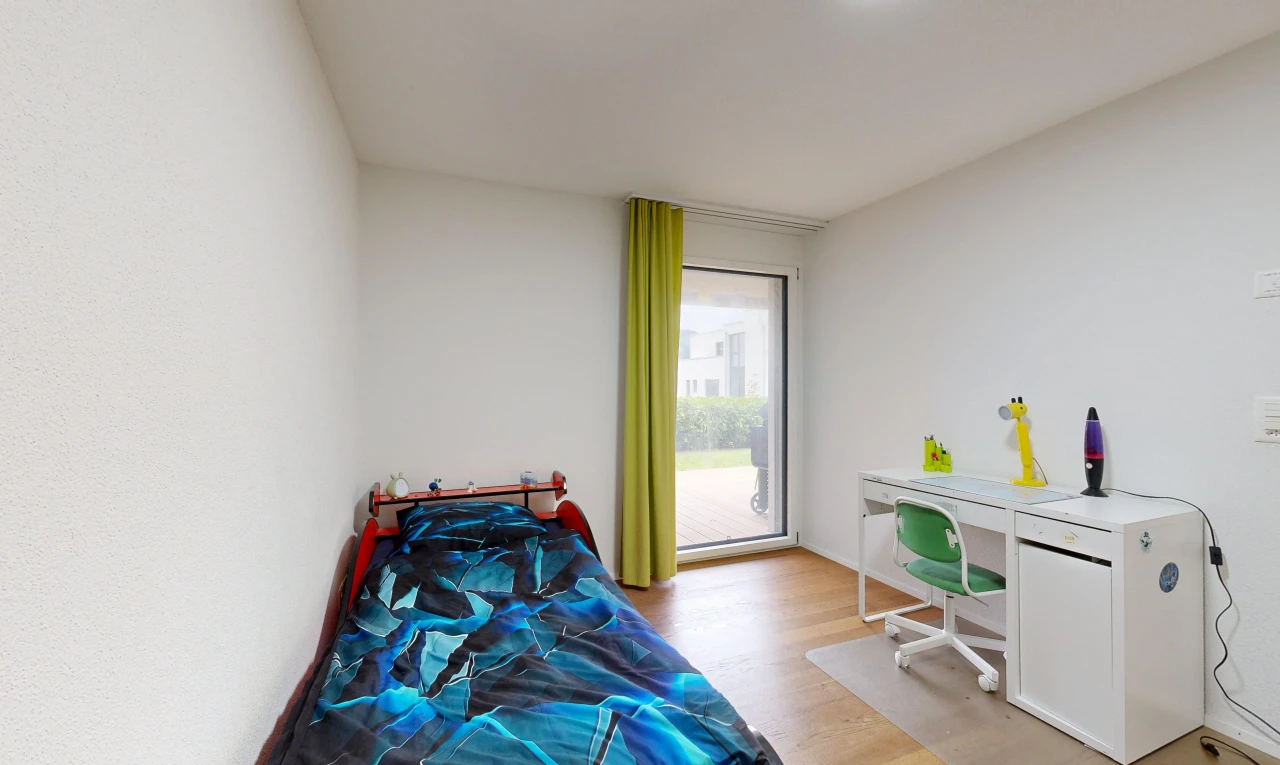 room / bedroom featuring an office area, light wood-style flooring, and access to outside
