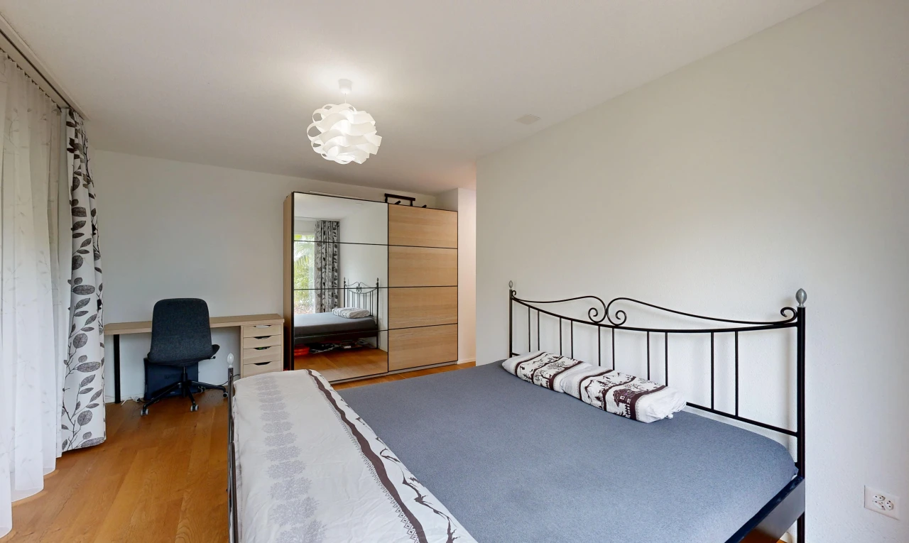 room with light wood-style flooring and an office area