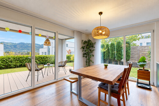 dining room featuring access to outside, pendant lighting, wood finished floors, and a mountain view