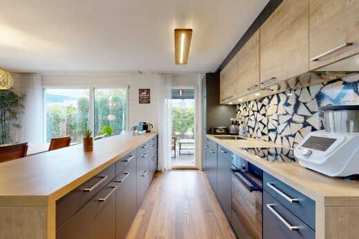 kitchen with light countertops, black appliances, modern cabinets, and access to outside