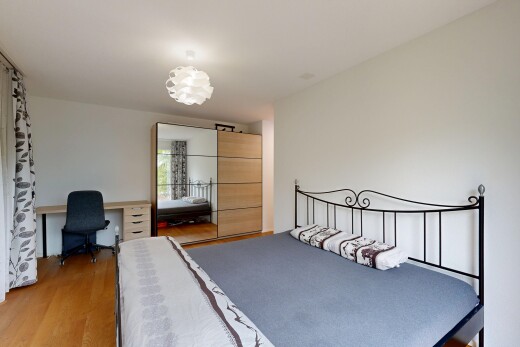 room with light wood-style flooring and an office area