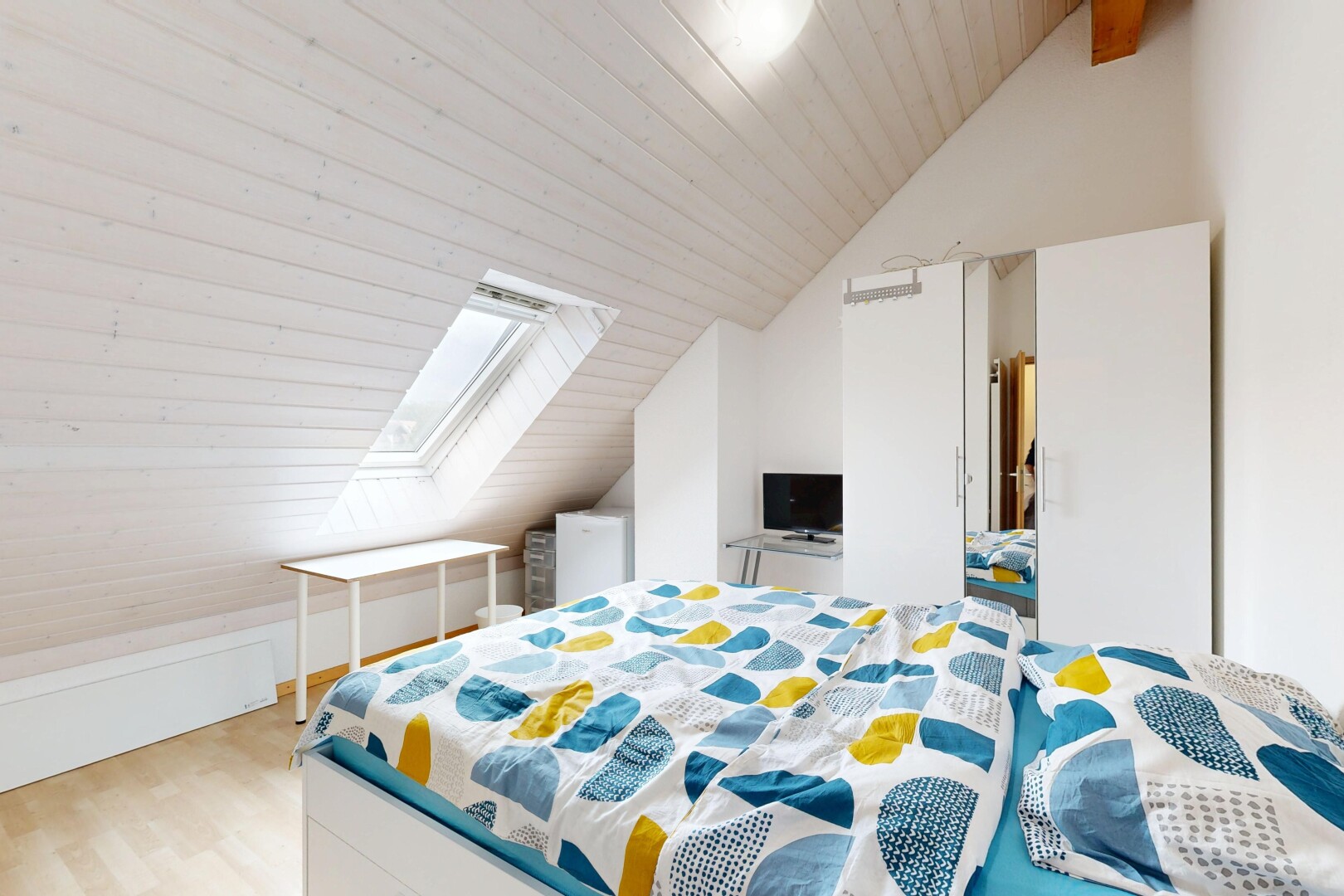 room with a vaulted wooden ceiling, light wood finished floors, and a skylight