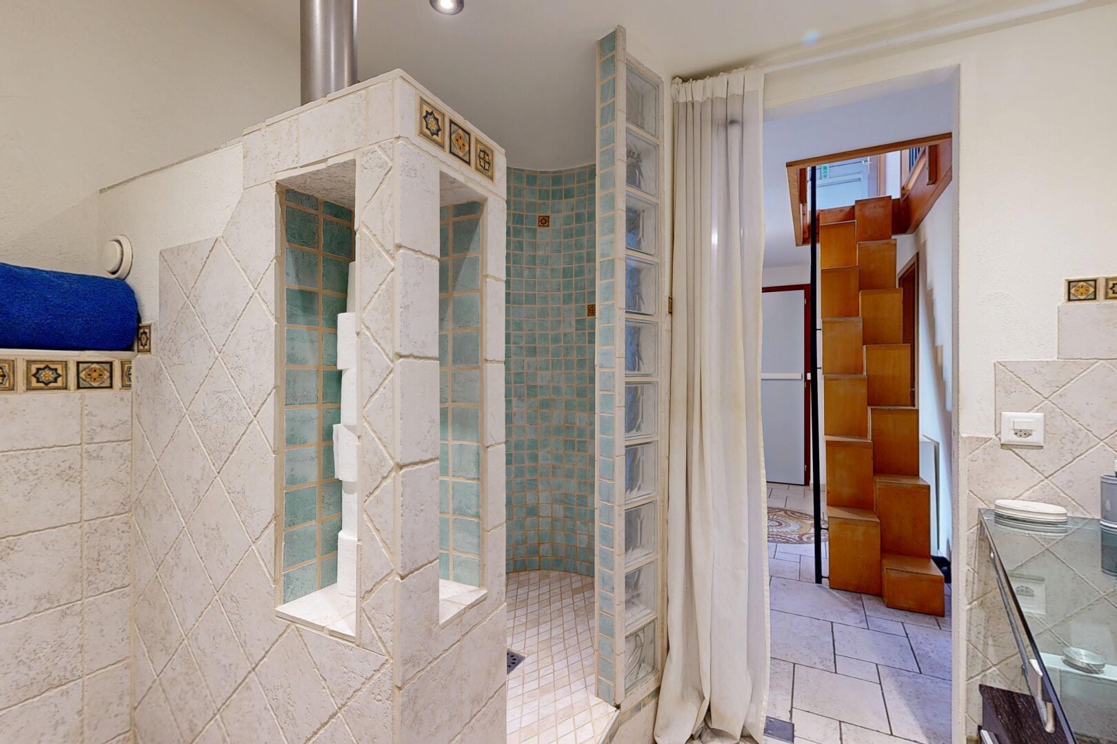 bathroom with tile walls, a walk in shower, and vanity