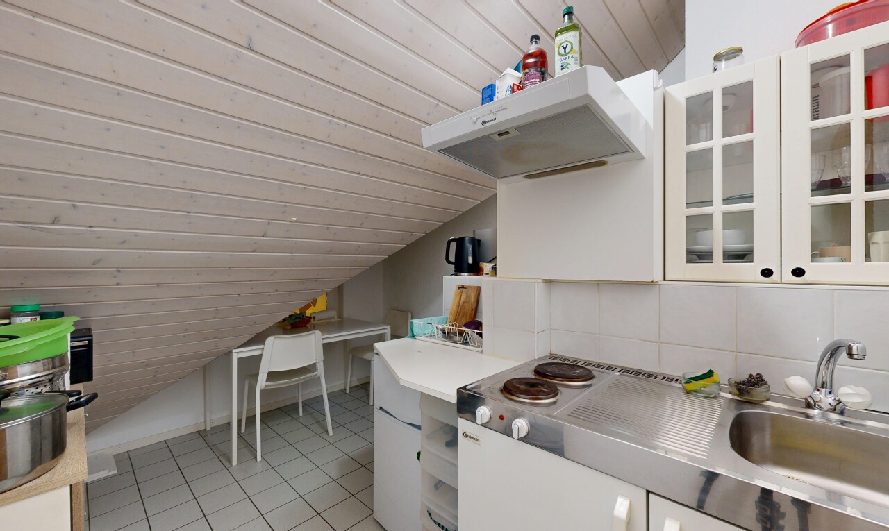 kitchen featuring glass insert cabinets, light countertops, range hood, a vaulted wood ceiling, and white cabinetry