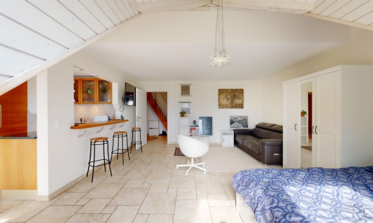 living room with stairs and a vaulted wood ceiling