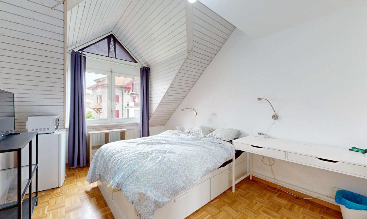 room featuring parquet flooring, vaulted ceiling, and radiator heating unit