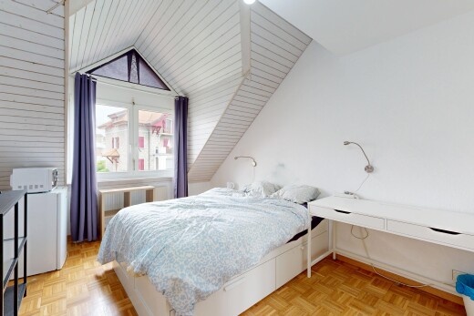 room featuring parquet flooring, vaulted ceiling, and radiator heating unit
