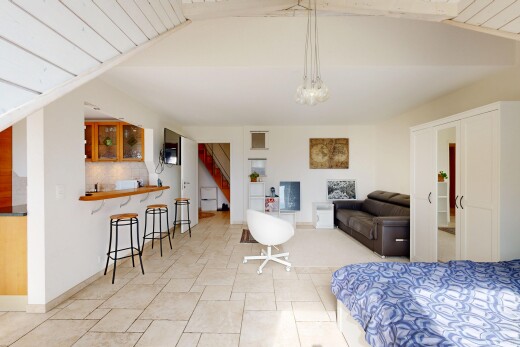 living room with stairs and a vaulted wood ceiling