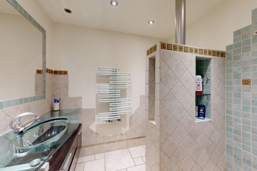 bathroom featuring vanity, tile walls, recessed lighting, light tile patterned floors, and radiator heating unit