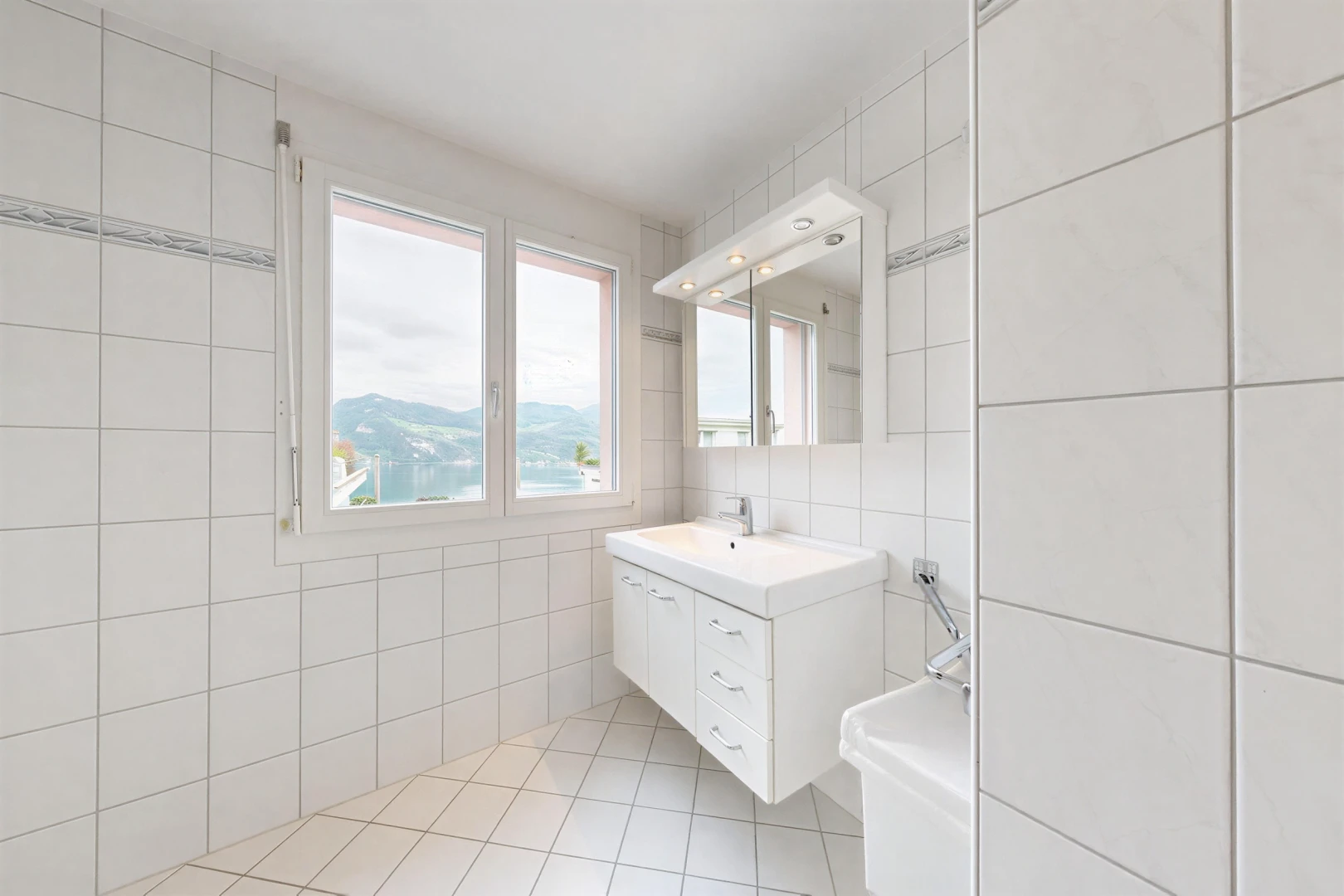 bathroom featuring tile walls, vanity, and light tile patterned floors