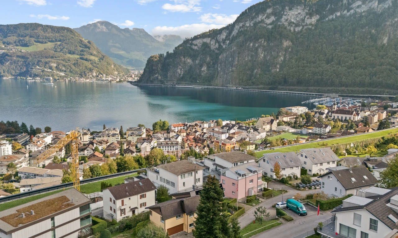 water view with a mountain backdrop and nearby suburban area