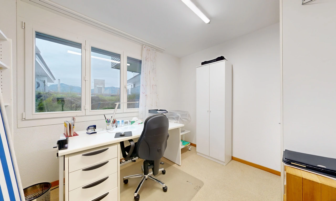 office space featuring light carpet and baseboards