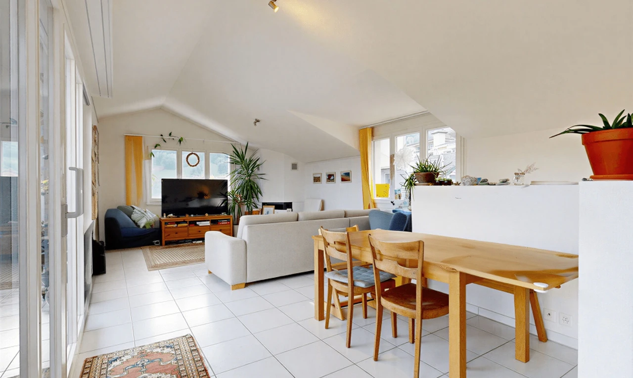 living room featuring lofted ceiling, healthy amount of natural light, and light tile patterned floors