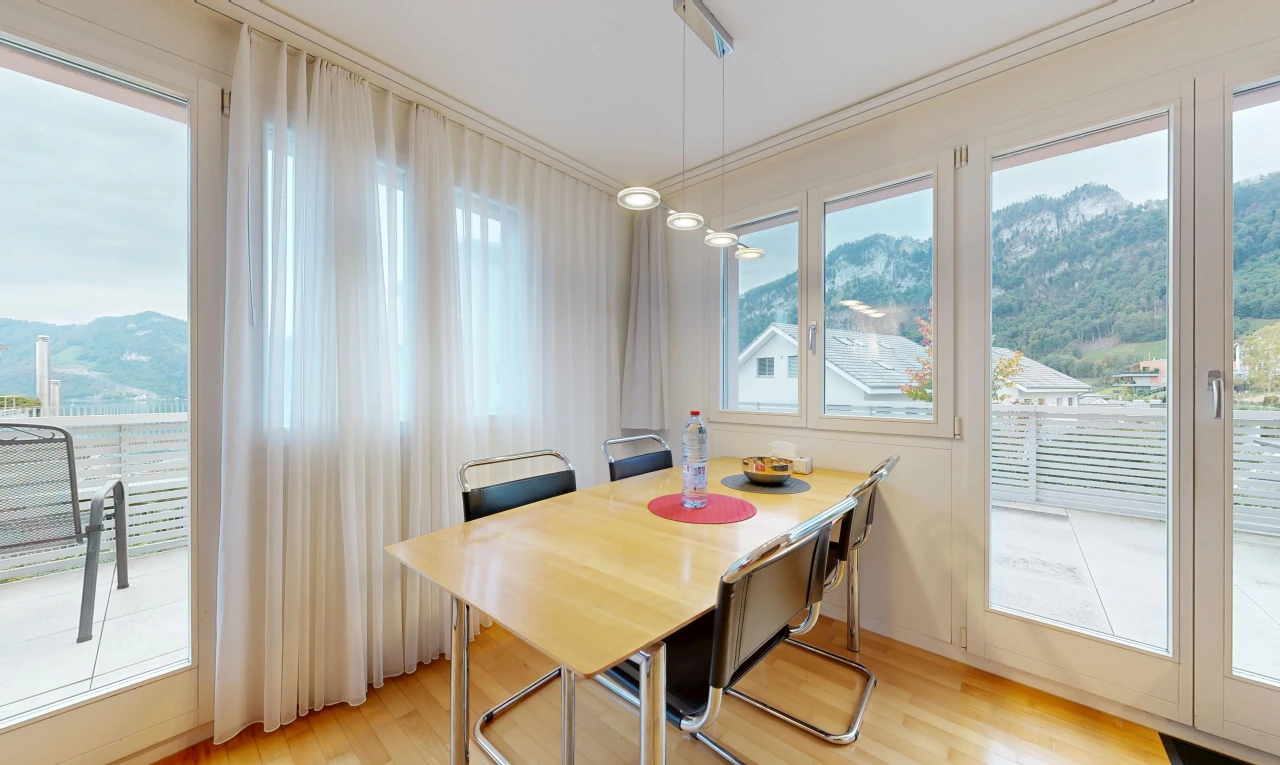 dining space with access to outside, a mountain view, light wood-style floors, and crown molding