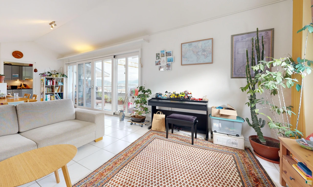 living room with lofted ceiling, access to exterior, and light tile patterned floors