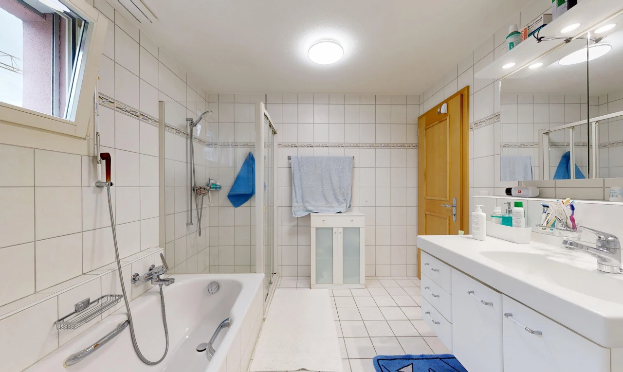 bathroom featuring tile walls, a bath, vanity, a stall shower, and light tile patterned floors