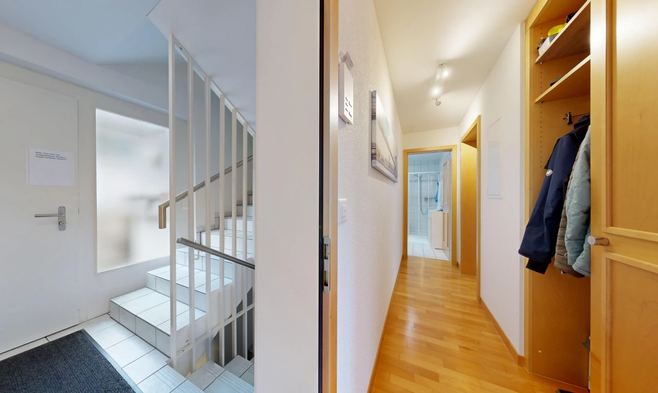 hallway with stairway and light wood-style flooring