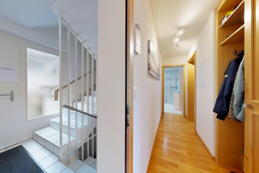hallway with stairway and light wood-style flooring